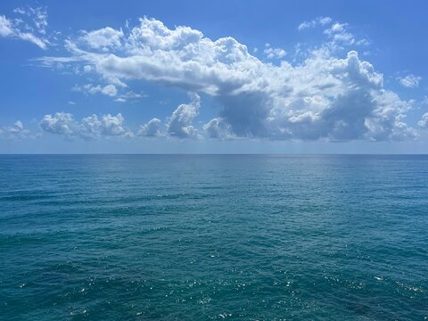 Beautiful sea and amazing clouds in the sky above blue water.