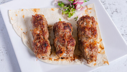 Lula kebab on plate top view