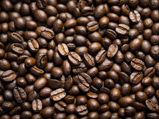 A close up of coffee beans with the beans being of different sizes