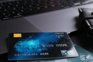 Credit cards and laptop on grey table, closeup