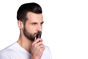 Close up side profile photo amazing he him his macho hairless process buy buyer new hand novelty ready remove nose ear hair with help comfy trimmer wear casual white t-shirt isolated grey background