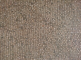 Big red stone and sea pebbles as frame on beach. Multicolor stone pebbles as natural abstract texture background with space for text. Close up colorful Pebble stone on coast. Filled full stone frame. 