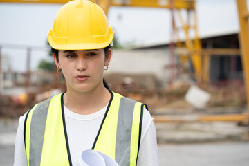 Tired Hispanic latin engineer woman at precast cement outdoor factory	
