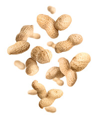 Unpeeled peanuts in air on white background
