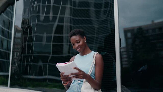 young woman engrossed in reading fiction book, cultivating her imagination and creativity. Her smile indicates enjoyment and engagement with story, highlighting joy of losing oneself in good book
