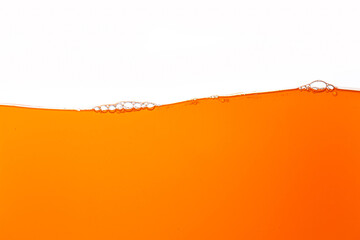 Fototapeta premium Macro orange juice texture isolated white background,Close up bright orange juice texture for health and nature waves