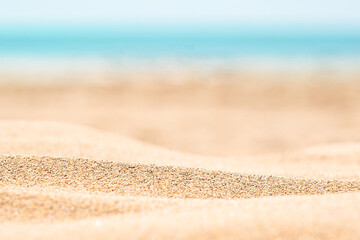 Sandy beach with horizon blue sea and sky background