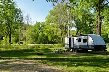 Gordijnen Travel trailer camping in the woods at Mississippi Palisades State Park, Illinois © dvande