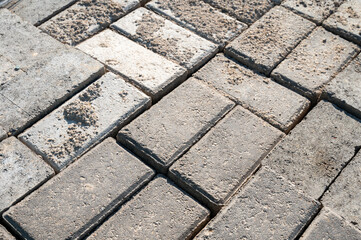 A close up of bricks on a sidewalk, highlighting the texture and pattern