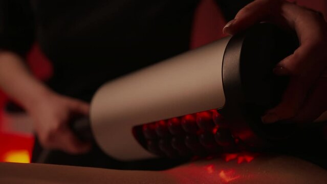 Therapist Or Cosmetologist Massaging Woman Back By RSL-Sculpting Apparatus With Roller, Closeup