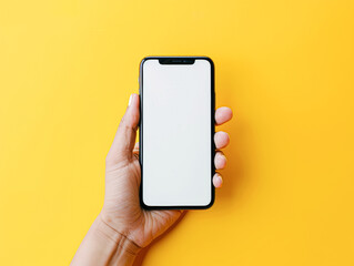 A person is holding a phone with a yellow background