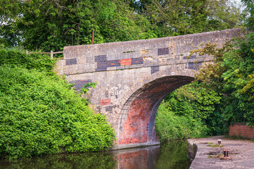 Fototapeta premium A summer HDR image of Bridge Number 140 over the Kennet and Avon Canal near Devizes Wharf, Wiltshire, England. 