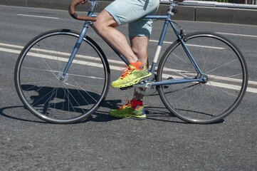 Hipster man and  his fixed gear bicycle on asphalt roadway