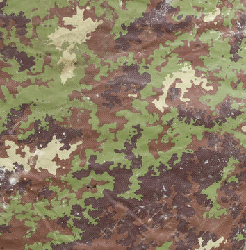 Military camouflage background with brown and green fabric in various shades for blending