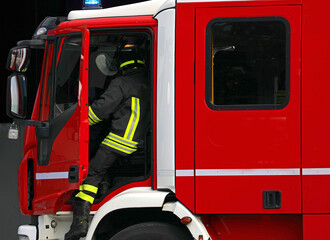 Firefighter swiftly disembarking fire truck during emergency