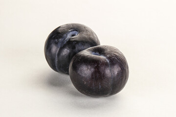 Two ripe sweet black plums