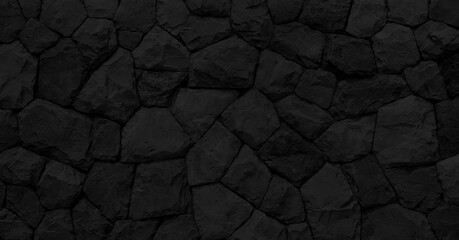 Empty black embossed stone wall for abstract background and texture for interior or exterior design. Beautiful patterns, space for work, banner, wallpaper close up.