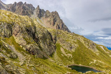 Tour du Montblanc beautiful mountain ladscapes of the Alps green valley, snow summit of Montblanc and rocky peaks of Aiguille du Midi in summer sunny weather blue sky, trekking and hiking in Chamonix