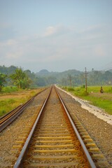 Fototapeta premium Railway tracks in rice fields. Beautiful views of rural Indonesia