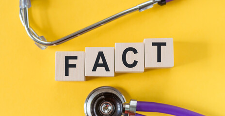 A stethoscope positioned next to the word fact, symbolizing the importance of factual information...