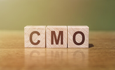 Wooden Block Spelling the Word CMO