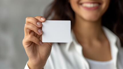 Cute girl holding white card at front of her lips with copy space on a white background