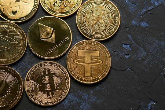 Variety of cryptocurrencies with dark textured background and view from above