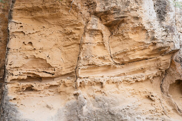 Texture of sandstone in a cave in the rays of the sun.
