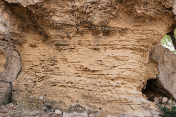 Texture of sandstone in a cave in the rays of the sun.