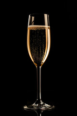 One glass of champagne on a black background