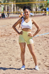 Portrait of a young sporty latin woman on the beach