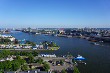High angle view of river and buildings against clear blue sky