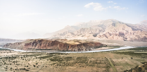 Panoramic mountain landscape in the mountains in the evening at sunset for background in the mountains of Tajikistan, the texture of hills and high mountains minimalist in the evening