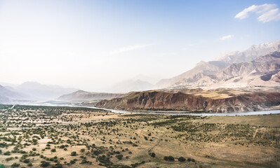 Panoramic mountain landscape in the mountains in the evening at sunset for background in the mountains of Tajikistan, the texture of hills and high mountains minimalist in the evening