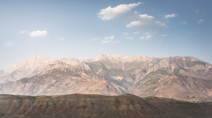 Panoramic mountain landscape in the mountains in the evening at sunset for background in the mountains of Tajikistan, the texture of hills and high mountains minimalist in the evening