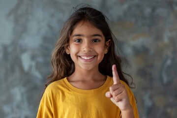Young woman in yellow top gives double thumbs up