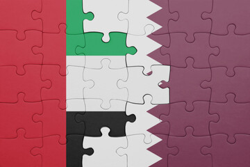 puzzle with the colourful national flag of qatar and flag of united arab emirates .