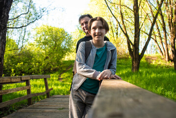 smiling boy in the park with his father