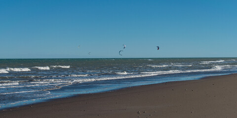 kitesurfing at the seashore on a windy afternoon