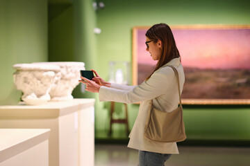 visitor in historical museum looking at art object