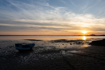Barque sur la plage au coucher du soleil