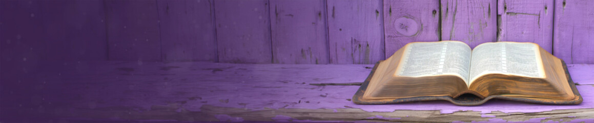 Fototapeta premium Open holy bible on a purple wooden surface. With extra wide copy space to add text. Holy scriptures. Ideal for blogs, presentations, religious meetings, Prayer groups and much more. Panoramic banner.