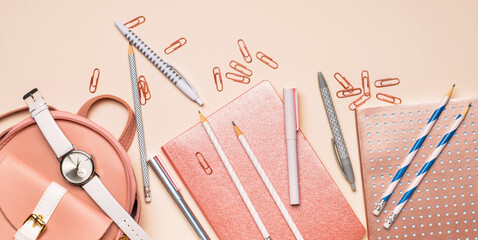 Set of school supplies with backpack on color background