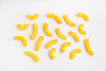 Tasty salty corn sticks on white background