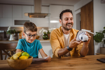 Fototapeta premium Father and son connect and install cctv security surveillance camera