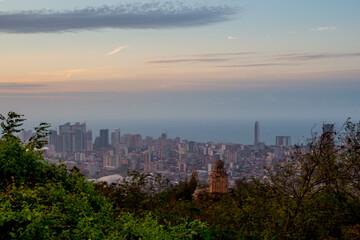 Sunset in the city. View of the city from the hill. Beautiful seaside town. 