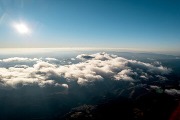 Natural cloudscape blue sky aerial view. Beautiful nature white clouds aerial view, blue sky horizon shooting from a drone on a sunny day high in the atmosphere front view