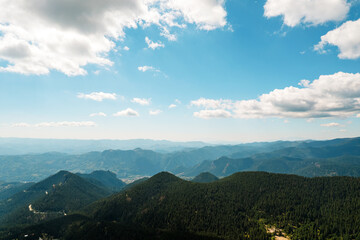 Moving white clouds blue sky scenic aerial view through summer. Drone slide turn flies forward high in blue sky through fluffy clouds on the panorama