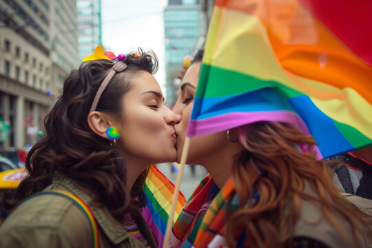 Two Women Kissing at Pride Parade with Rainbow Flag and Colorful Decorations Celebrating Love and Diversity