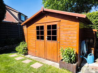 Wooden garden shed in a summer